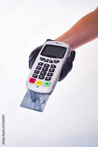 Submits a payment terminal. Hands with gloves. Seller's hand in a glove.Safe shopping concept