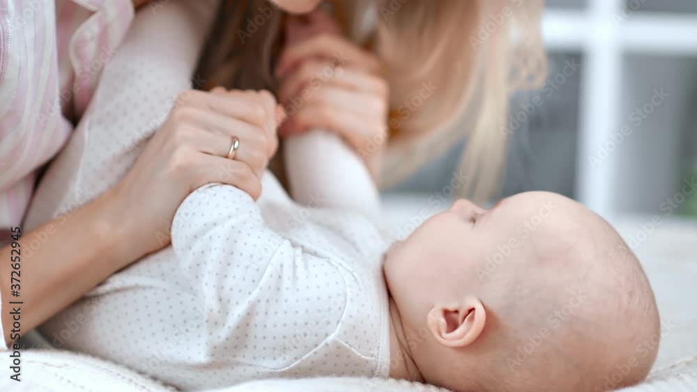 Joyful young mother playing with toddler enjoying motherhood. Close up shot on 4k RED camera