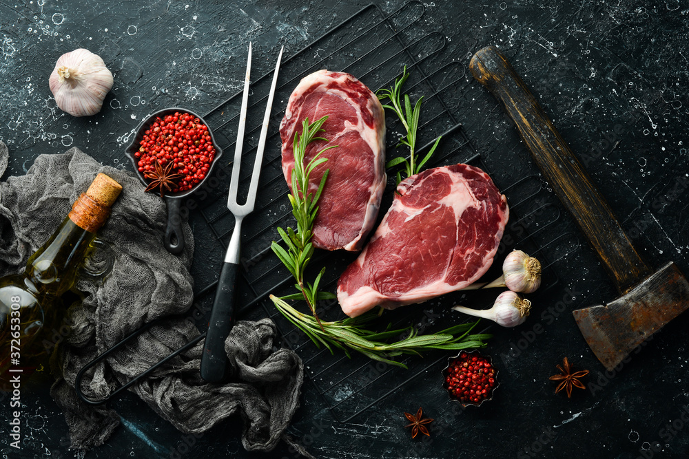 Raw meat, beef steak on dark background. Top view. Free space for your text. - obrazy, fototapety, plakaty 