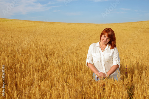 redhead woman in wheat field
