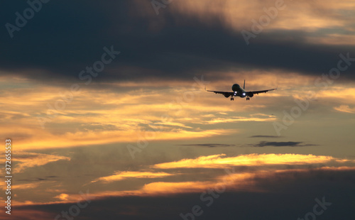 plane flying against dawn sky