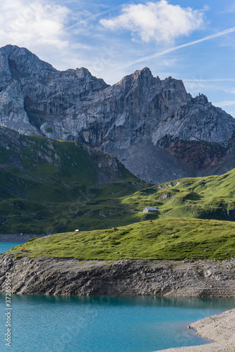 Mountain panorama at Lunersee, Austria. With a turquoise lake, green grassland and rocks in the background. photo