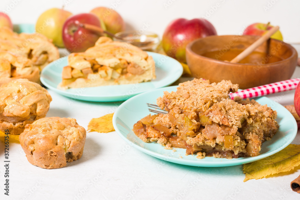autumn baking concept with seasonal apples and cinnamon honey. crumble crisp apples on a plate on a light background with autumn yellow leaves. autumn baking concept with seasonal apples and cinnamon honey. crumble crisp apples on a plate on a light background with autumn yellow leaves.