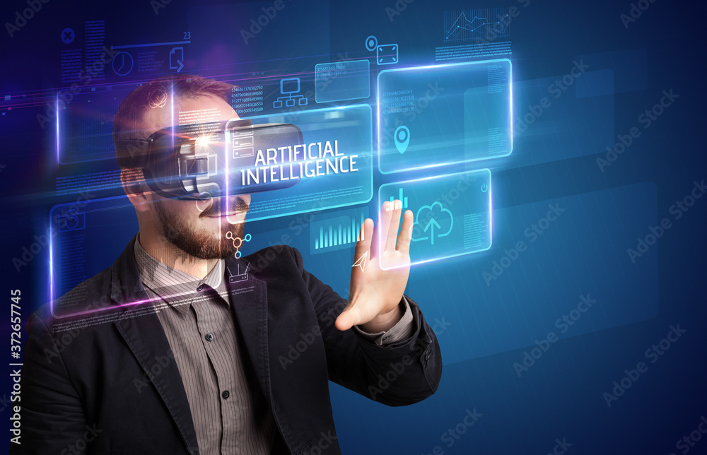 Businessman looking through Virtual Reality glasses with ARTIFICIAL INTELLIGENCE inscription, new technology concept