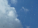 Rain drops on the window with cloud and sky background after the rain