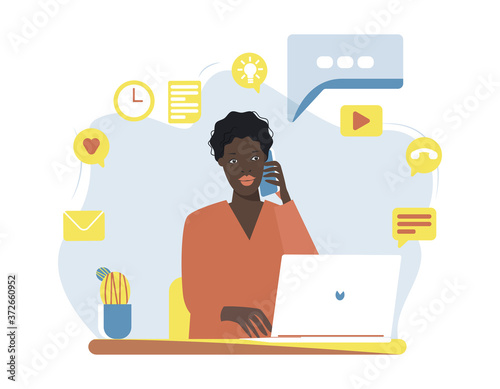 Black female character sitting at a desk, working on a laptop and answering to a phone call. Distant communication. Working from home concept. Flat vector illustration. Design template elements, etc.