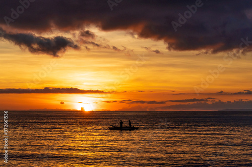 Fishermen catch fish at a beautiful sunset
