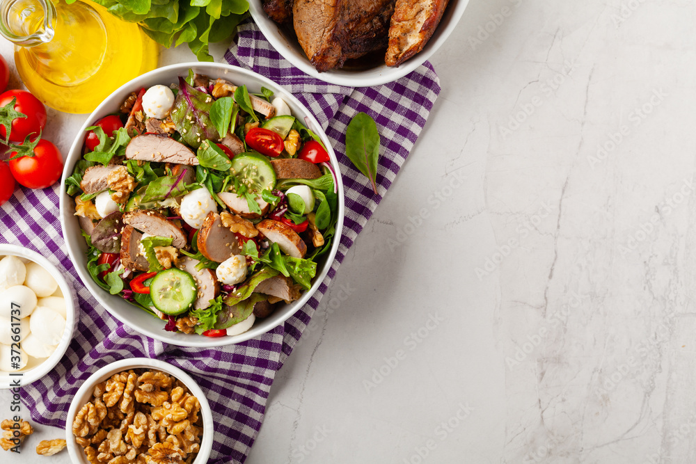 Salad with pork tenderloin, fresh cucumber and mozzarella. Salad with pork tenderloin, fresh cucumber and mozzarella.