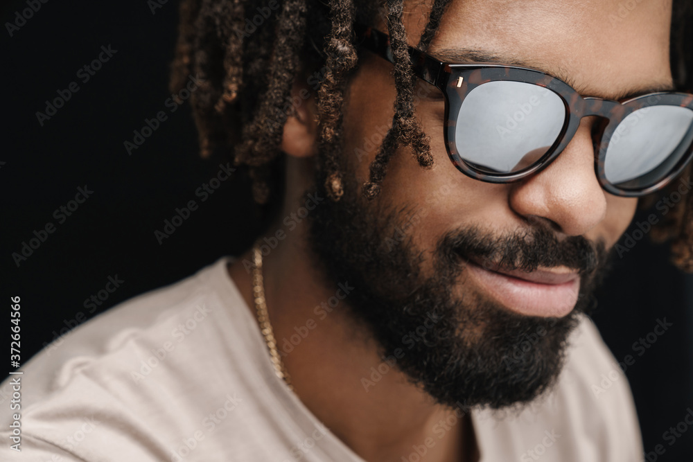 Fototapeta premium Pleased optimistic guy in sunglasses