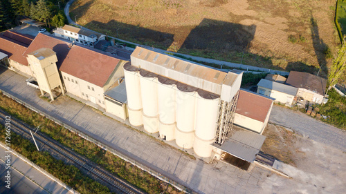 Aerial view of feed silos near the driveway and railroad. 