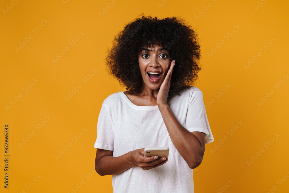 Image of african american girl screaming and using mobile phone Image of african american girl screaming and using mobile phone