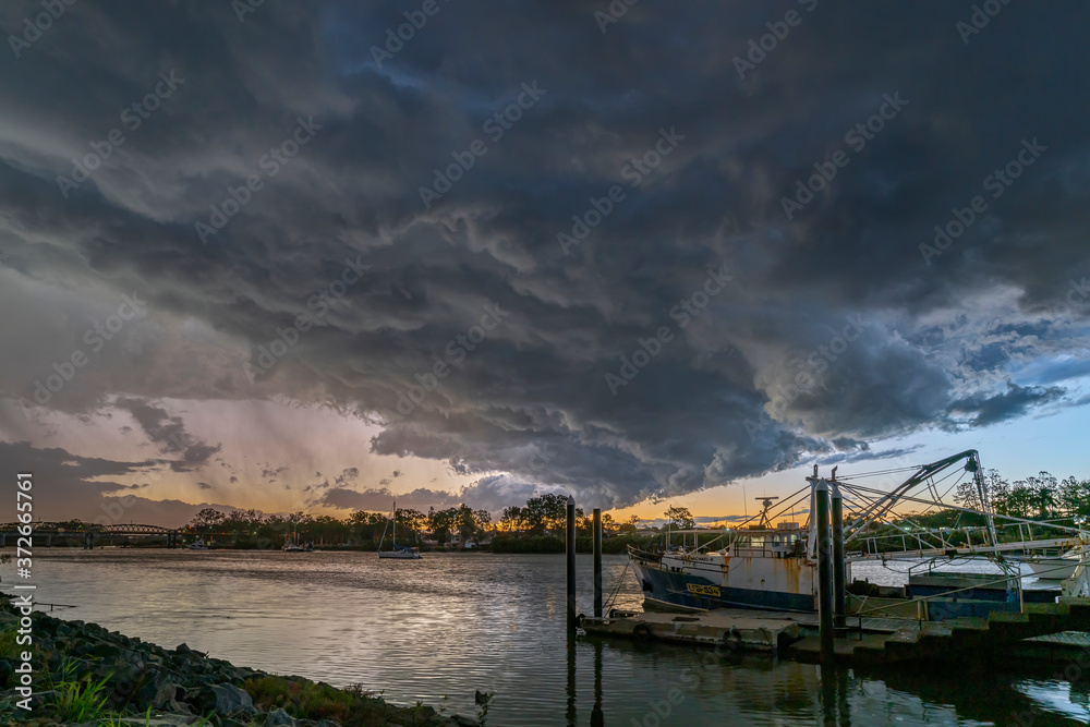 A storm front passes over the river. 