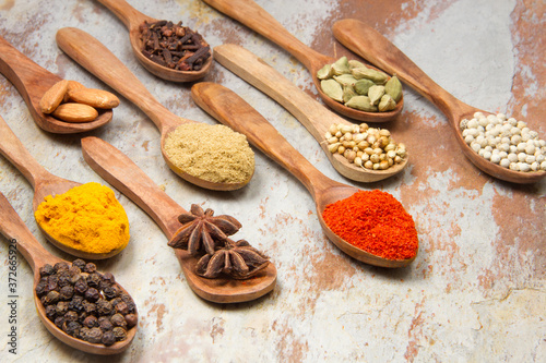 Aromatic spices on wooden spoons. Food ingradients.