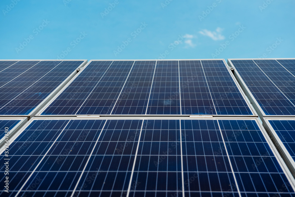 Photovoltaic power plant. Solar photovoltaic panels on blue sky background Photovoltaic power plant. Solar photovoltaic panels on blue sky background