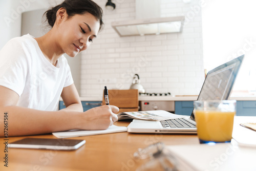 Happy asian female student learning online