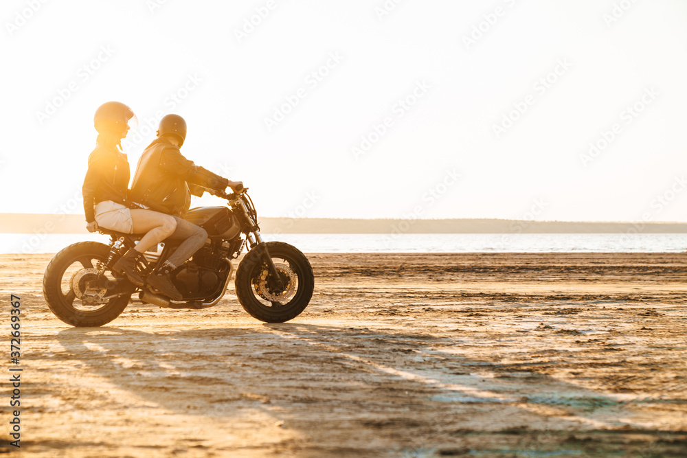 Fototapeta premium Beautiful young stylish couple enjoying ride on a motorbike