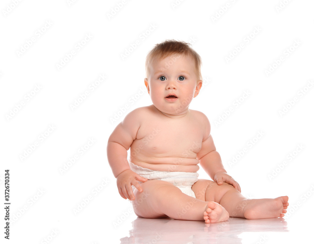 Baby boy with surprise looks at the camera on a white background. Baby boy with surprise looks at the camera on a white background.