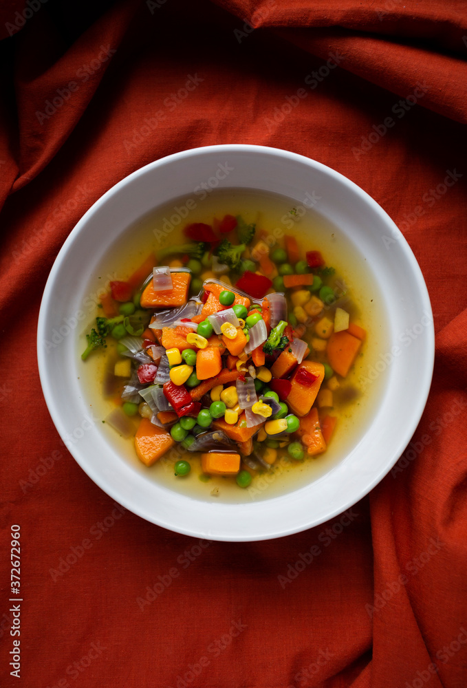 vegan vegetable soup on a red background vegan vegetable soup on a red background