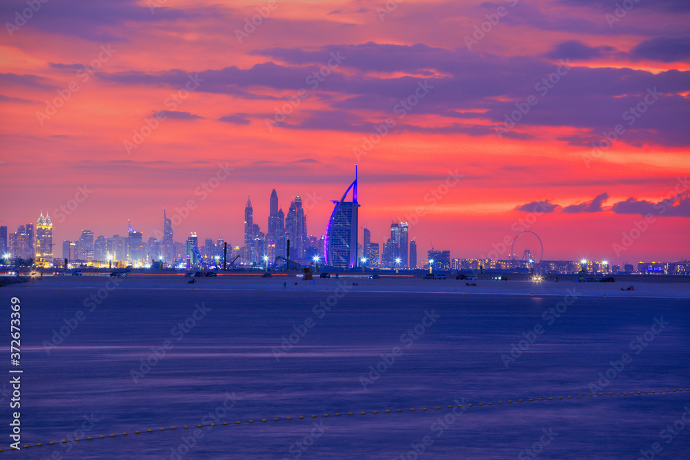 Amazing sunset view of Luxury hotel in Dubai with futuristic skyline in background