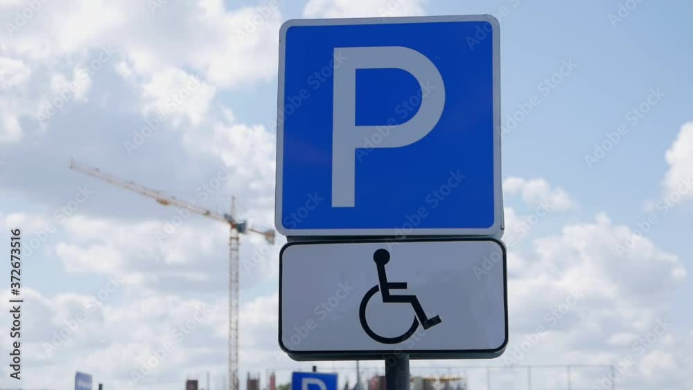 Parking sign for a disabled persons on the mall parking Parking sign for a disabled persons on the mall parking