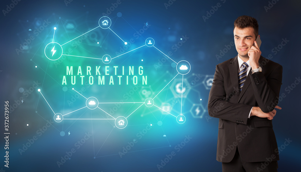 Businessman in front of cloud service icons with MARKETING AUTOMATION inscription, modern technology concept Businessman in front of cloud service icons with MARKETING AUTOMATION inscription, modern technology concept