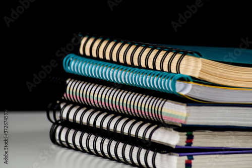 pile of spiral wire notebooks