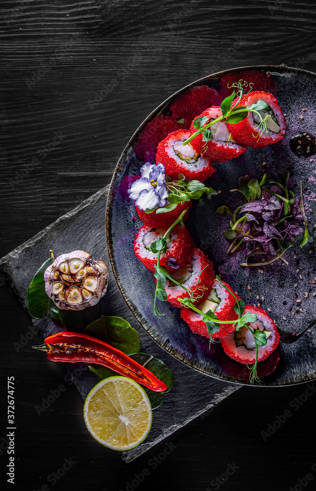 Fototapeta premium Sushi. Philadelphia roll with fresh salmon, cucumber, avocado, cream cheese, tobiko caviar