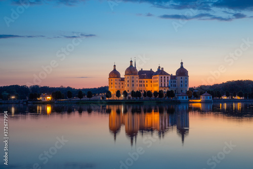 Beautiful evening panorama of Moritzburg Baroque palace surrounded by a lake. © scimmery1