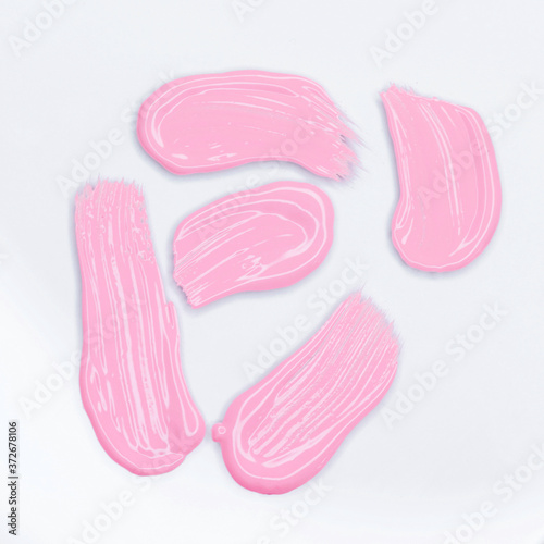 Pink Lipstick smudge isolated on white. Top view, flat lay.