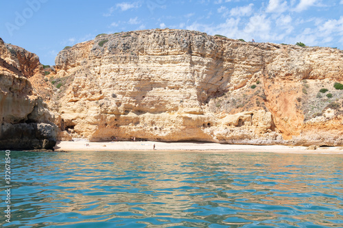 View from the sea of Carvoeiro beach. The Lagoa region has a coastline formed of towering cliffs, turquoise waters and picturesque beaches. The beaches of Carvoeiro are found within sheltered coves