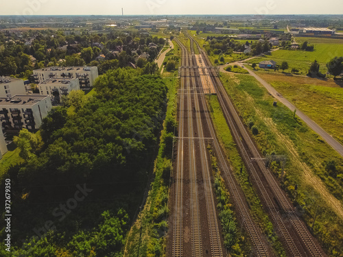 Railway near real estate on the outskirts of city. Drone  aerial view.