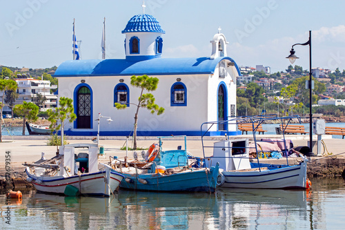 fishing boats and  the chapel of Saint Nikolaos  in the port of Nea Artaki in Euboea, Greece.  Sunny summer day 
 photo