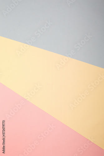 Pastel pink, blue and yellow background. Holiday invitation mockup. Flat lay, top view, overhead. Minimal style. Abstract geometric multicolored watercolor paper background in soft pastel trend colors