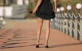 beautiful girl legs in black dress outdoors