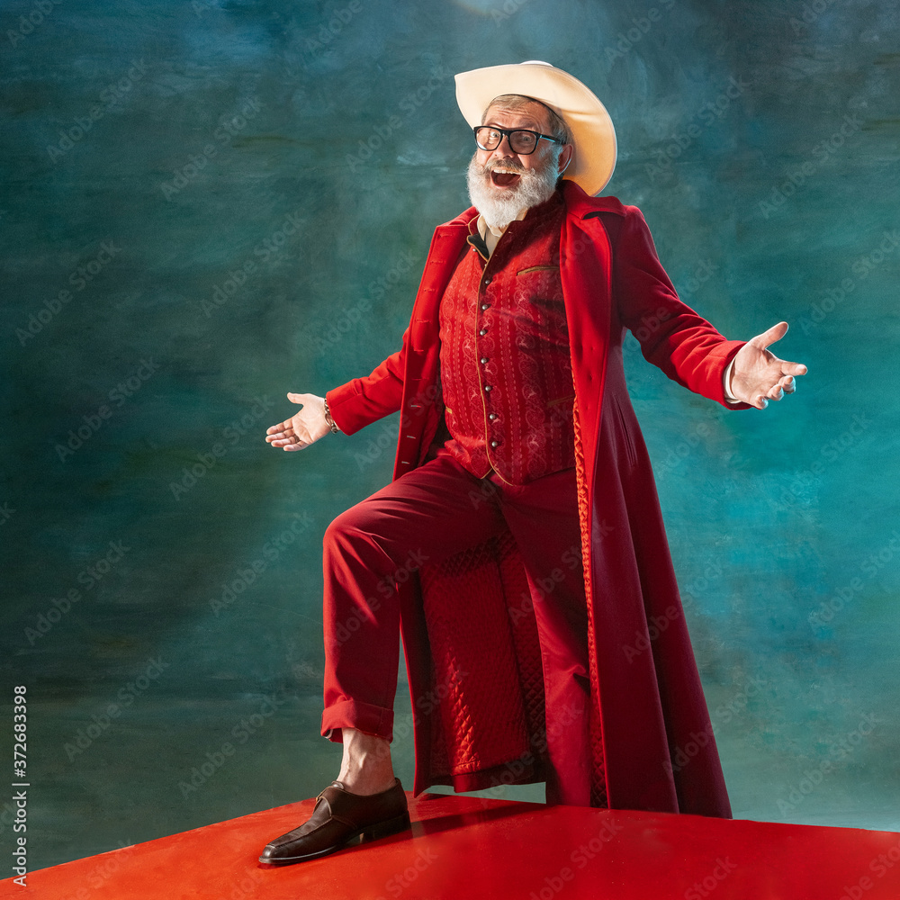 Performing. Modern stylish Santa Claus in red fashionable suit and