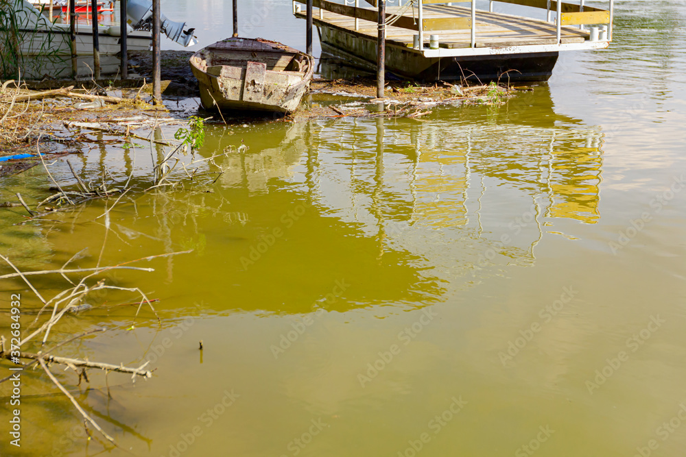 Makeshift pier on polluted river coast Makeshift pier on polluted river coast