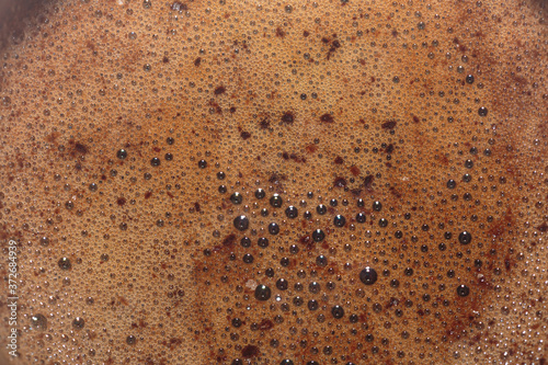 Natural foam of Turkish coffee closeup. Concept of art background.