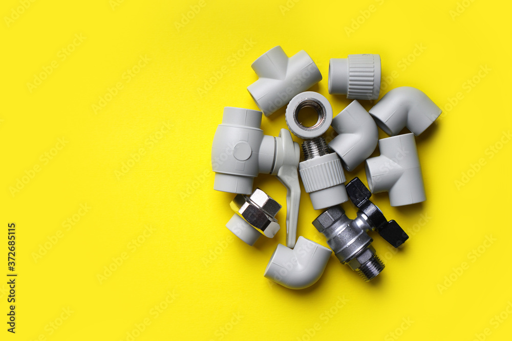 Plumbing pipe details on a yellow background. Copy space. Plumbing pipe details on a yellow background. Copy space.