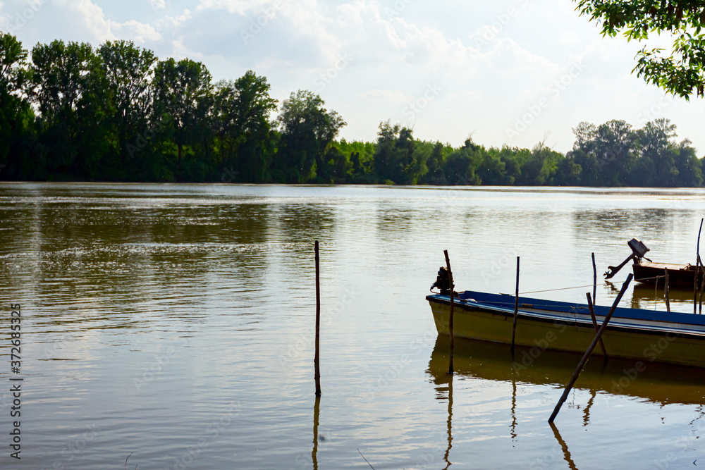 Motor boats are docked in the shallow water