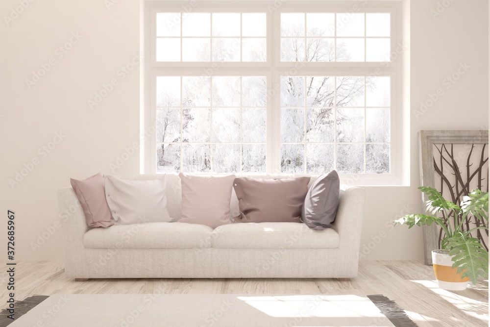 Fototapeta premium White stylish minimalist room with sofa and winter landscape in window. Scandinavian interior design. 3D illustration