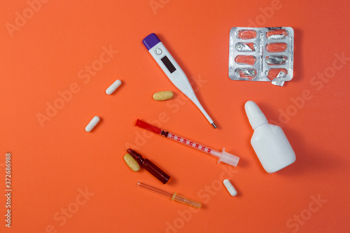 Medicines for cold and flu on red background