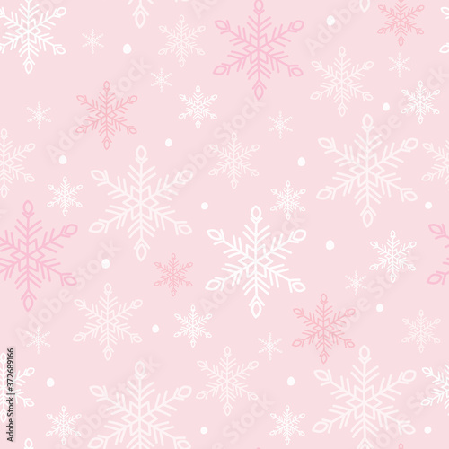 Snowflakes seamless pattern. White snow crystals on light pink background. Great for winter fabric, textile, Christmas wrapping paper, scrapbooking. Surface pattern vector design.