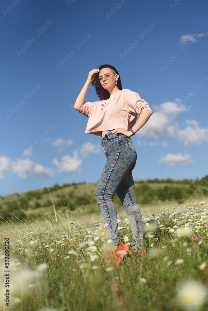 Portrait of beautiful young woman standing in chamomile field. Portrait of beautiful young woman standing in chamomile field.