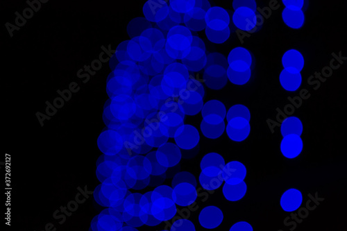 Blue garland out of focus. Blue blurred circles. Good New Year spirit.