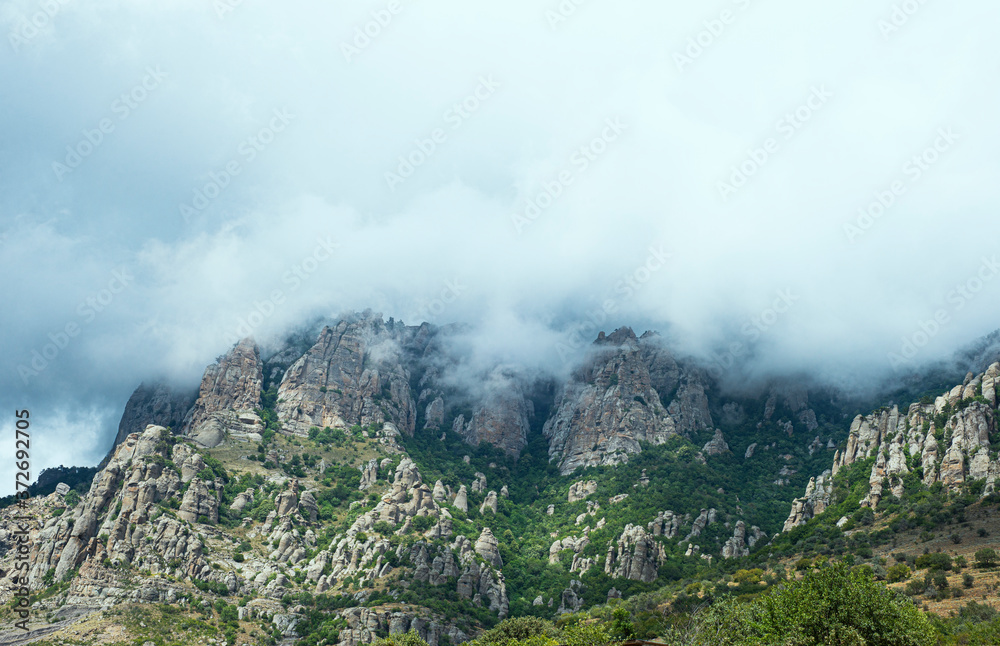  Mountain landscape panorama. A cloudy sky looms over the mountain range. Copy space for text.