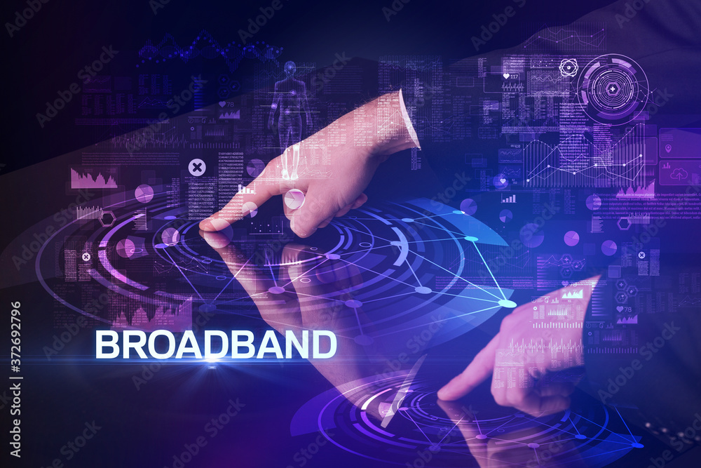 Businessman touching huge display with BROADBAND inscription, modern technology concept