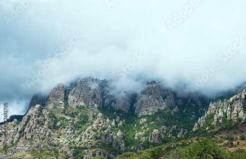  Mountain landscape panorama. A cloudy sky looms over the mountain range. Copy space for text.