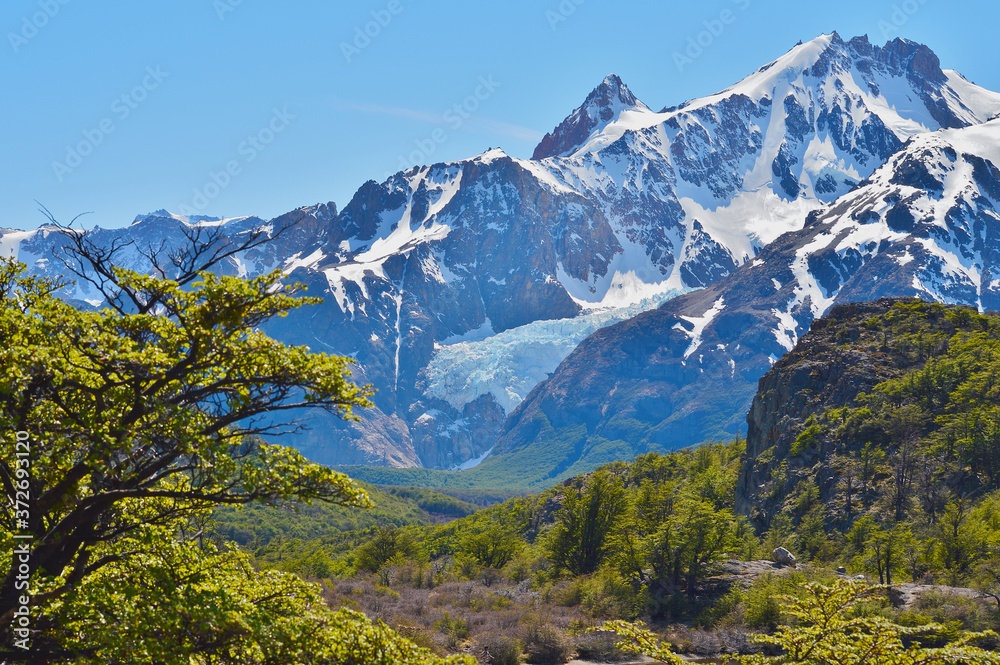 light white snow on mountain with white cloud and blue sky and fantastic green forest nature.