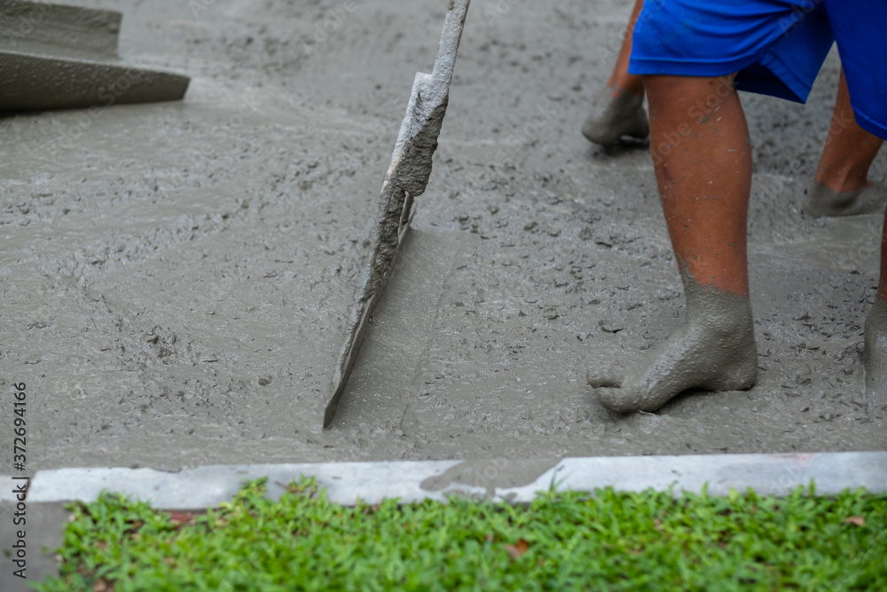 Workers are pouring, concrete and equipment
Workers are pouring, concrete and equipment