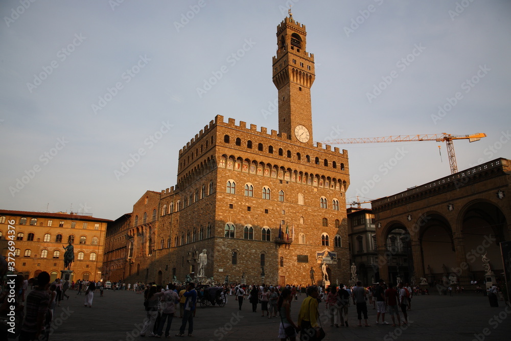 Tourists visit Piazza della Signoria during sunset in Florence, Italy